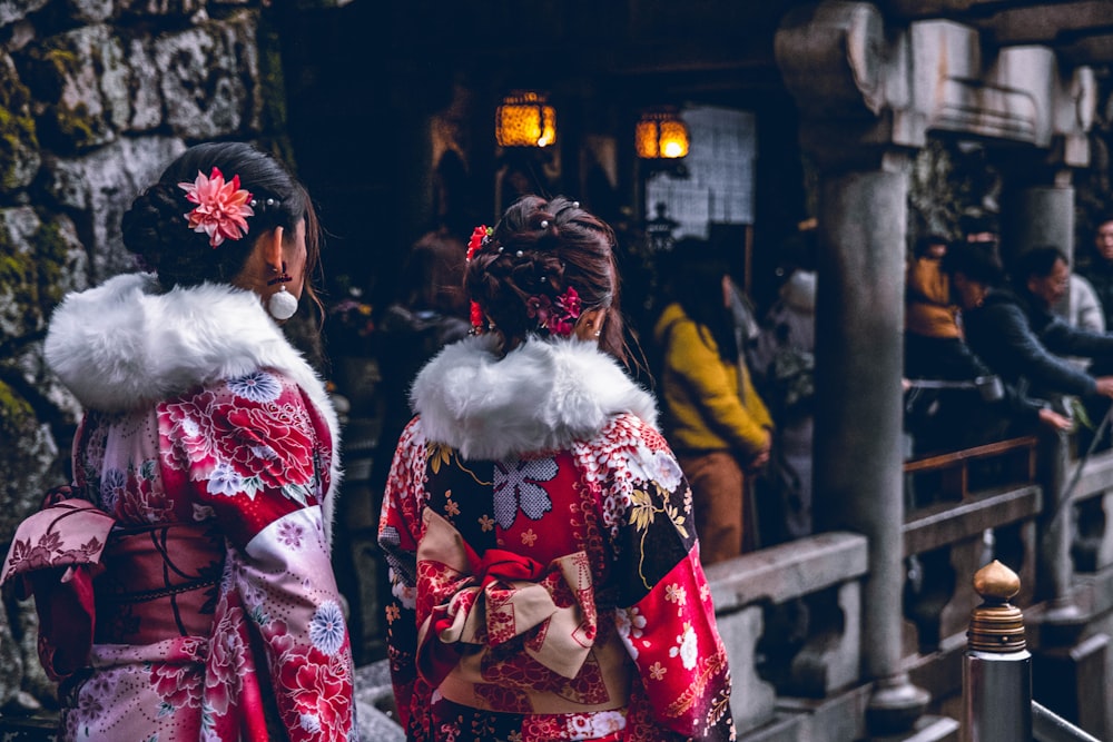 two women in red and white floral kimono dresses