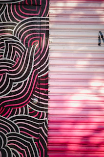 Close-up of a mural featuring gentle swirls of pink and purple hues with subtle heart shapes.