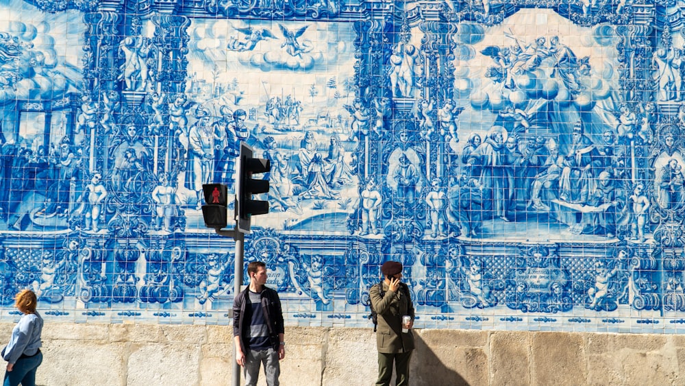 men standing beside wall