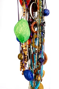 Assorted handcrafted necklaces combining different materials and textures.
