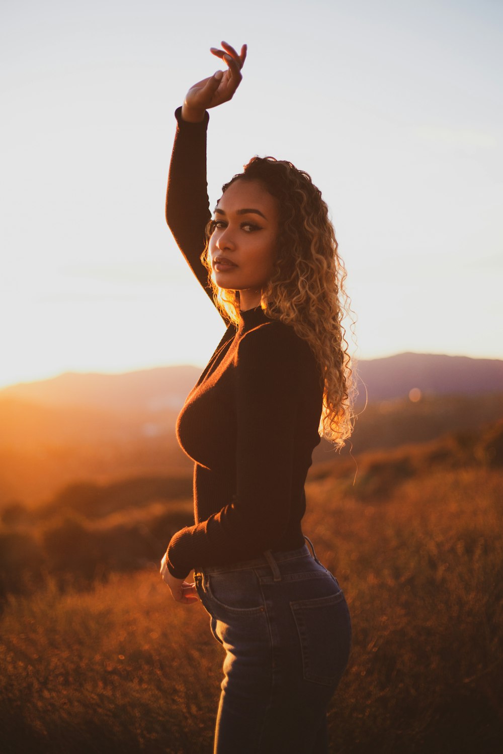 woman in black sweater and blue denim jeans