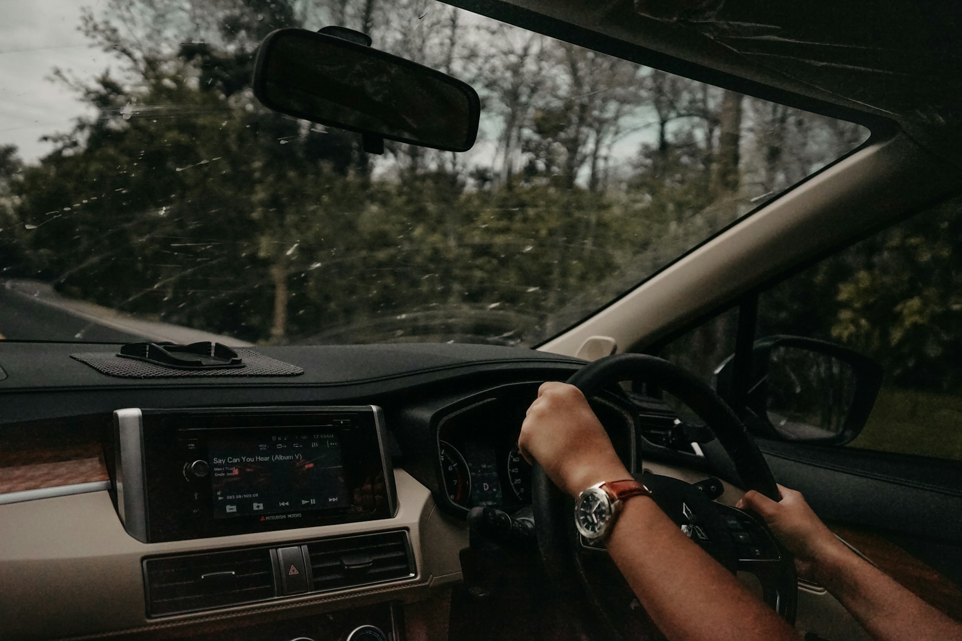 person wearing watch driving vehicle