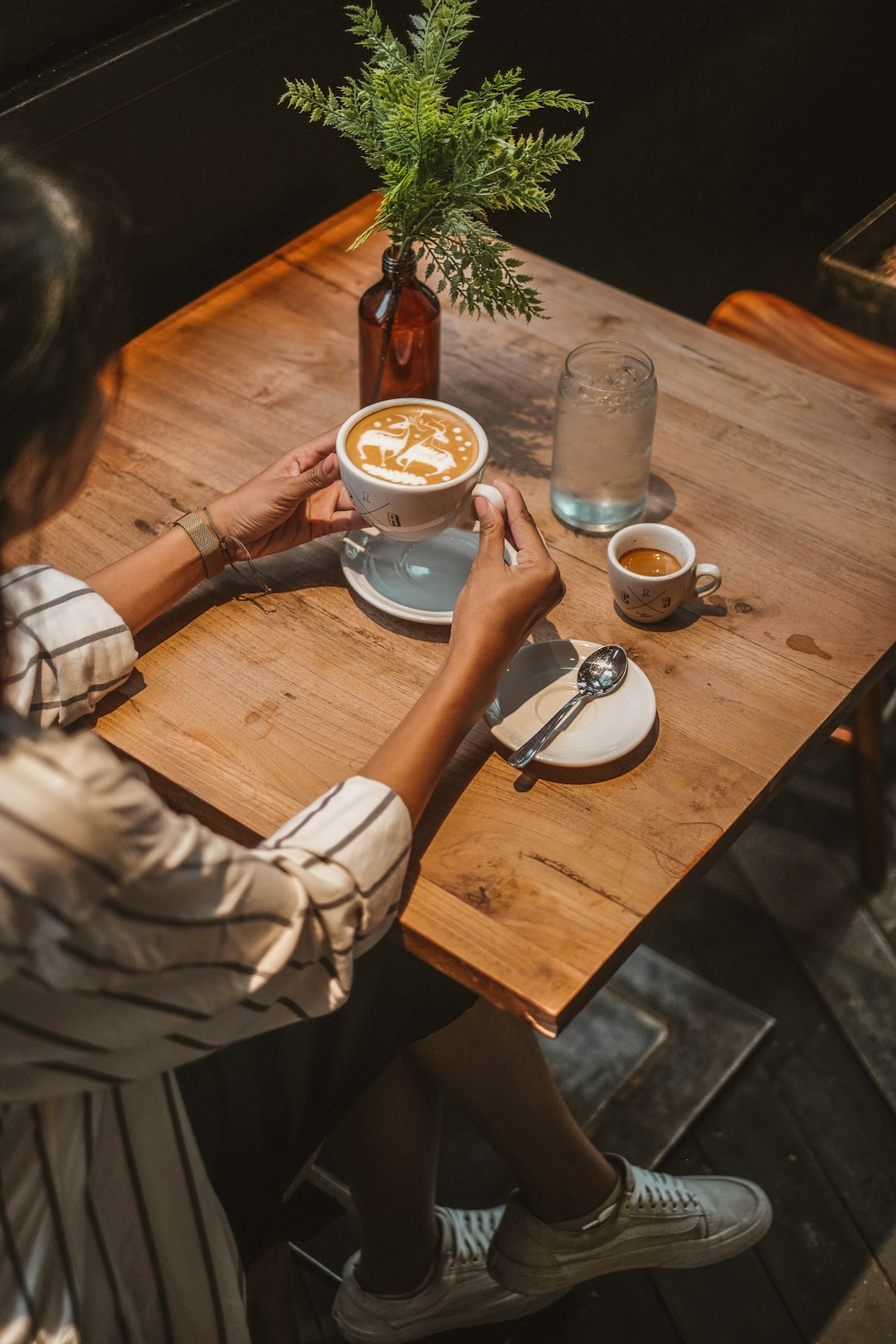 woman drinking coffee beside table