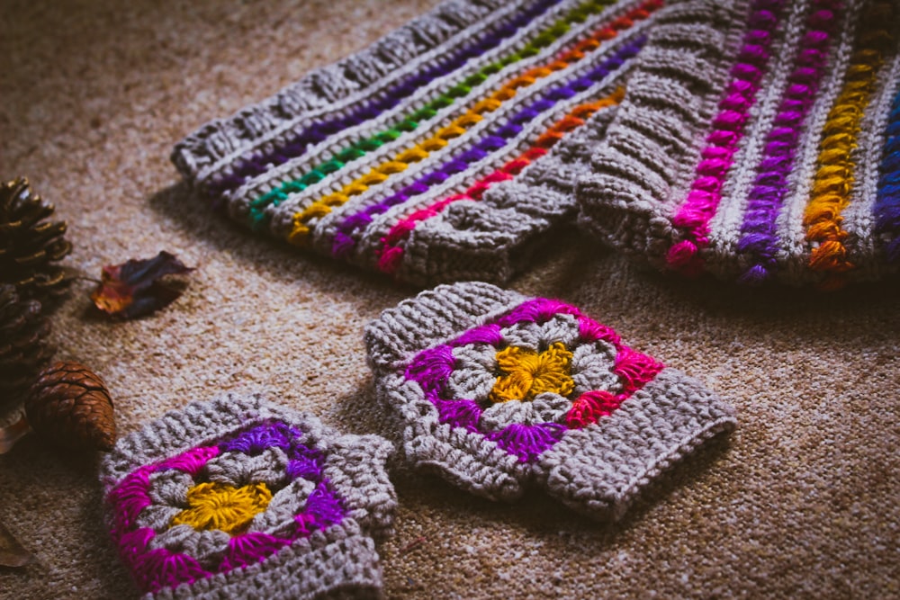 gray, orange, and purple crochet gloves