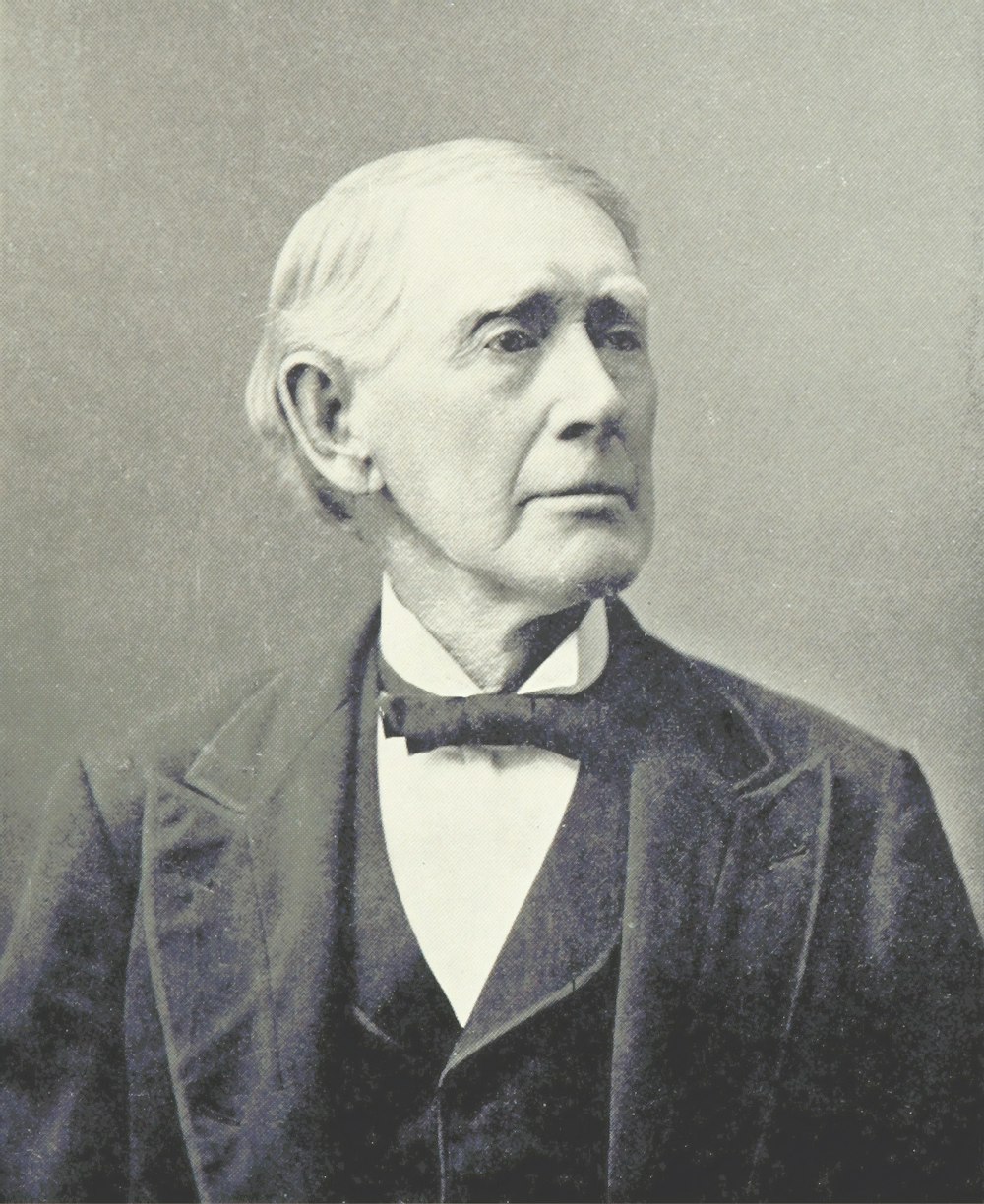 grayscale photo of man in tuxedo