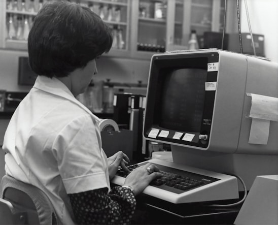 grayscale photography of unknown person using computer