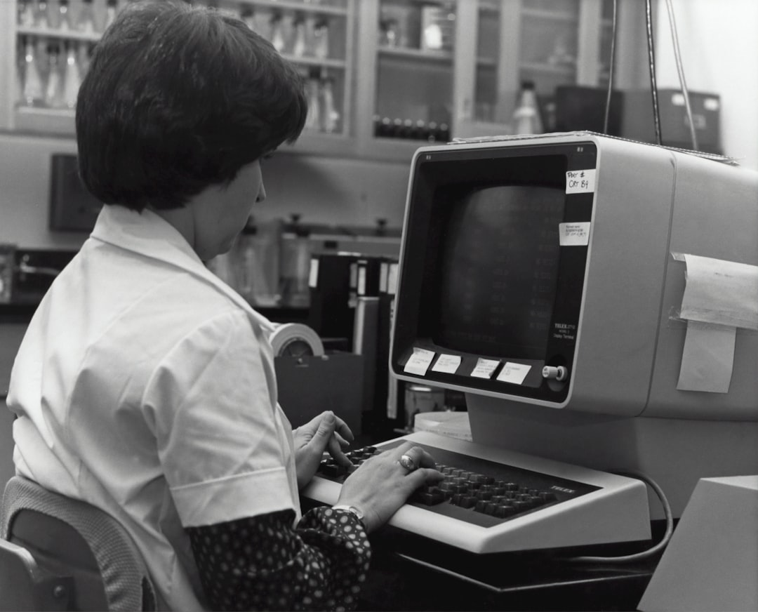 grayscale photography of unknown person using computer