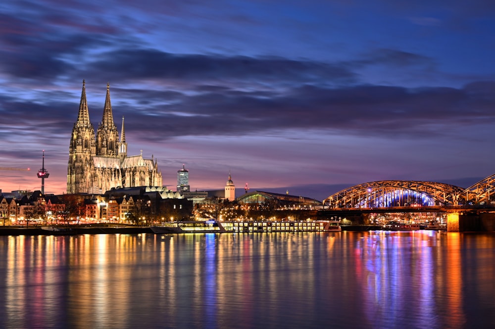 lighted city buildings near body of water