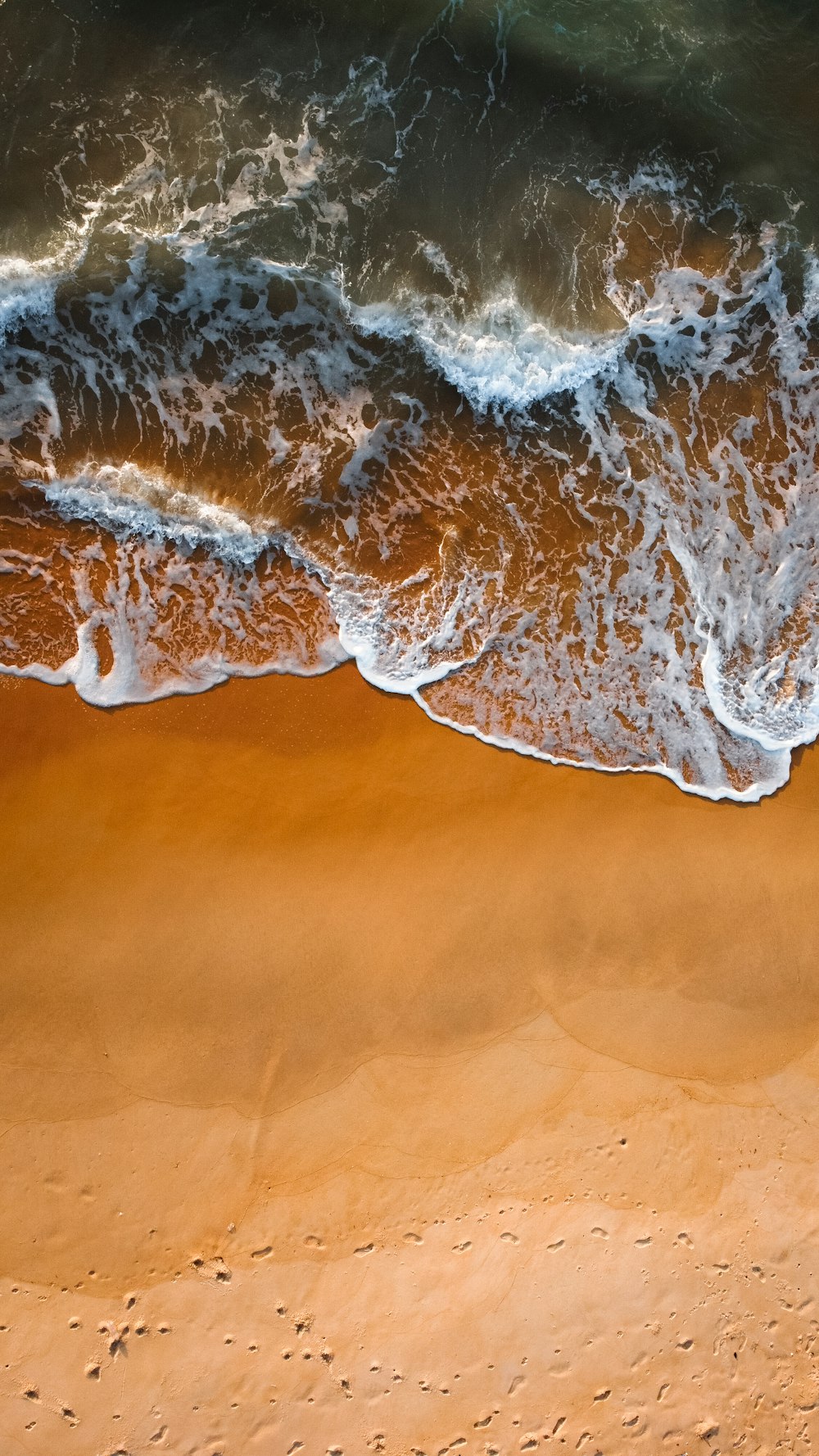 aerial view of sea bubbles on shore