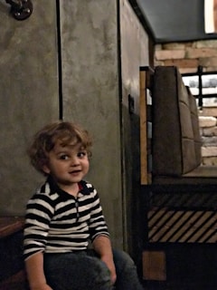 A calm child sitting with a caring child psychiatrist in a softly lit, welcoming office.