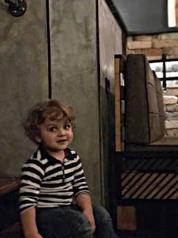 A calm child sitting with a caring child psychiatrist in a softly lit, welcoming office.