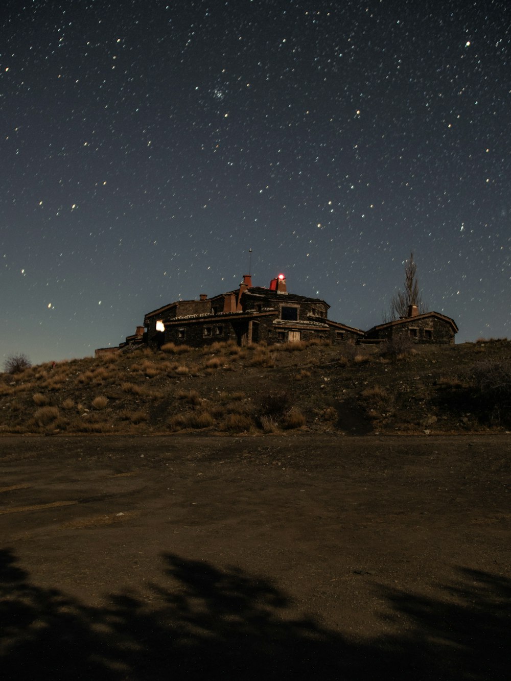 building on mountain under starry night