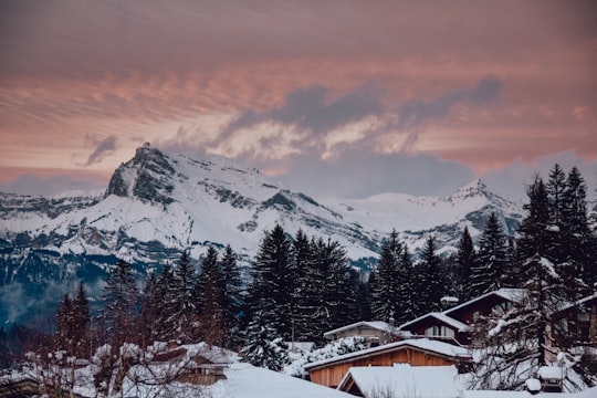 snow capped rocky mountain under cloudy sky during golden hour in Megève France