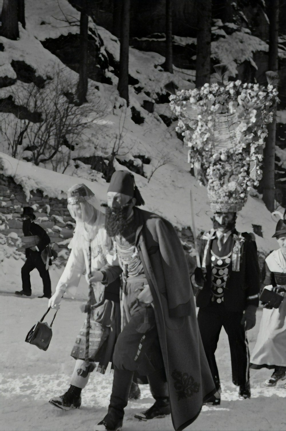 Graustufenfotografie von Männern, die auf Schnee gehen