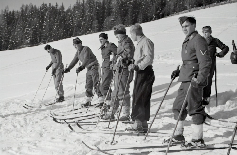 grayscale photography of people doing snow skies during daytime