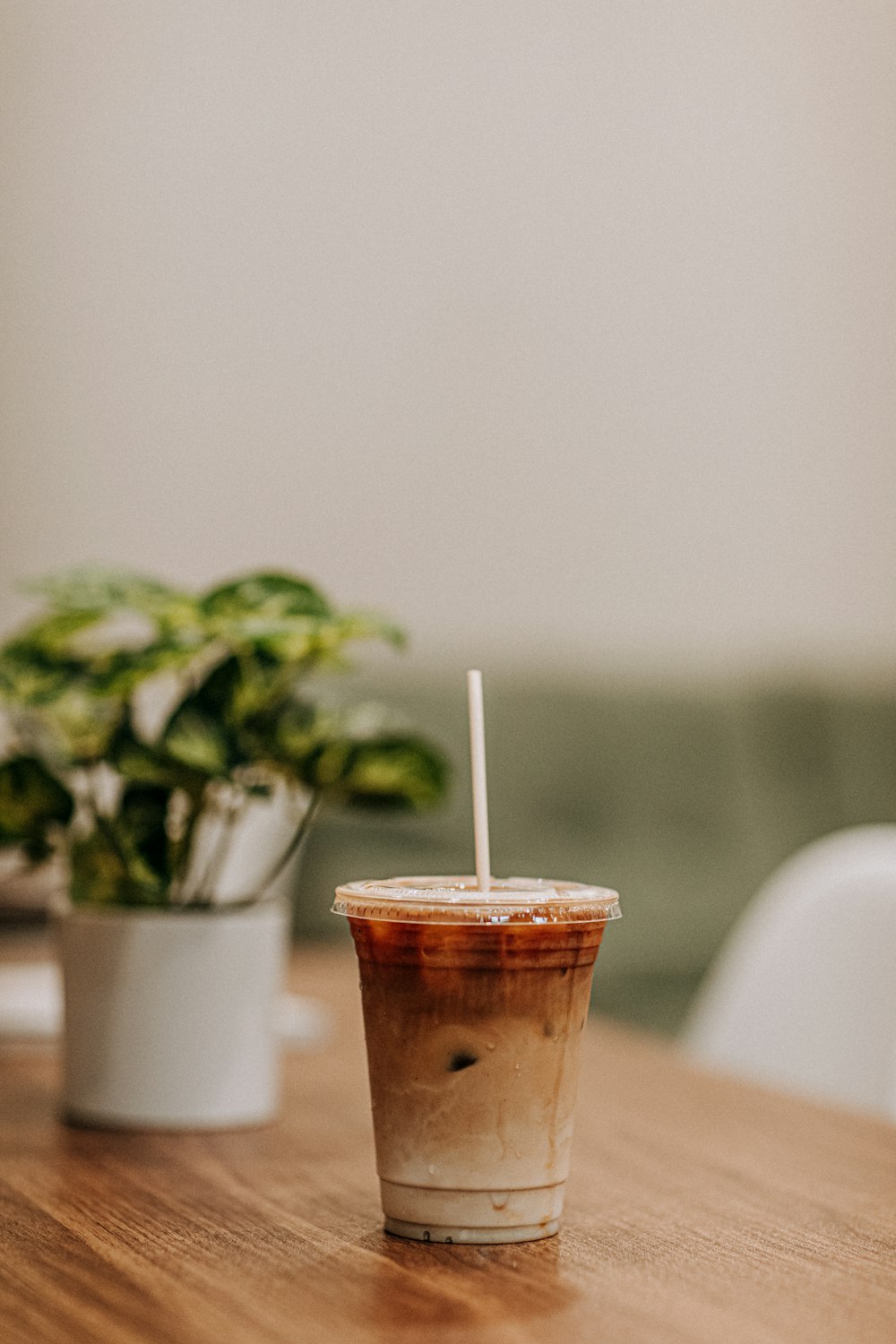 disposable cup with lid filled with brown liquid