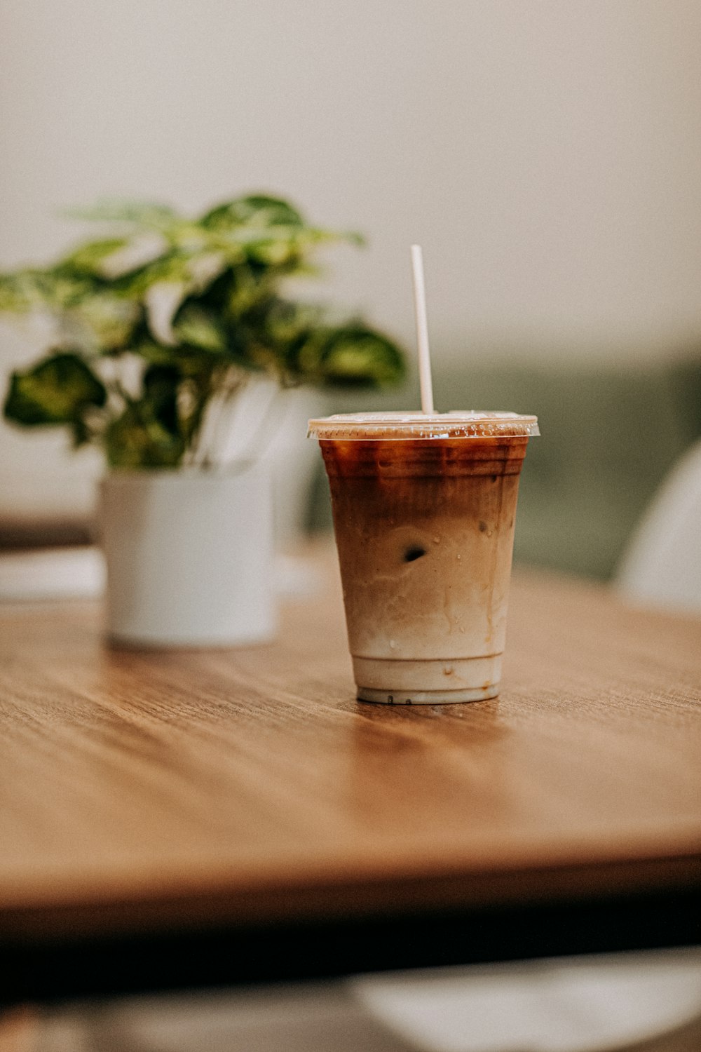 disposable cup with lid filled with brown liquid