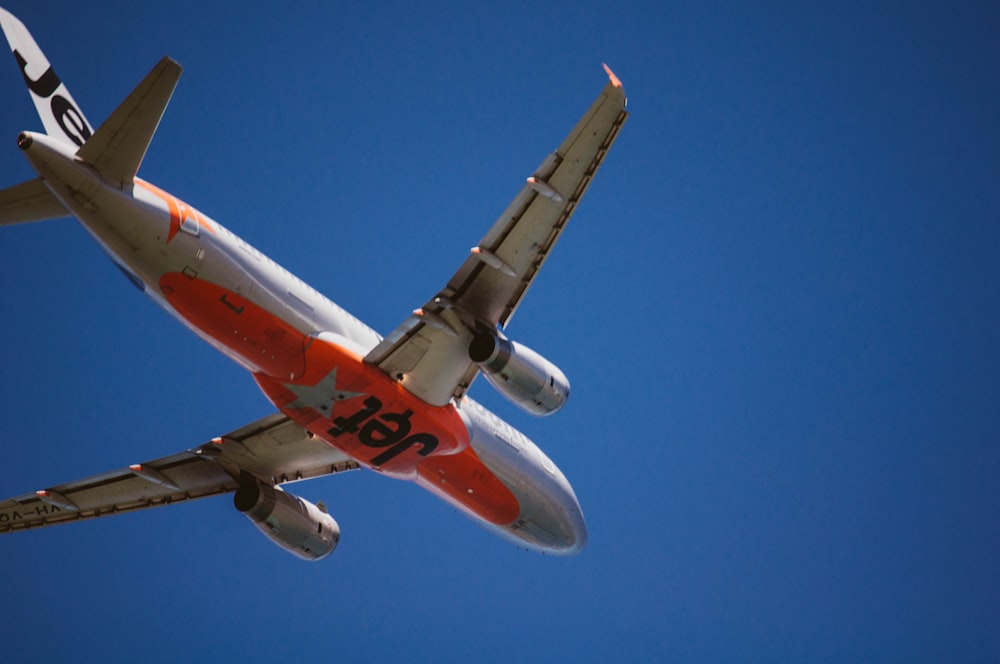 gray and orange Jet airplane