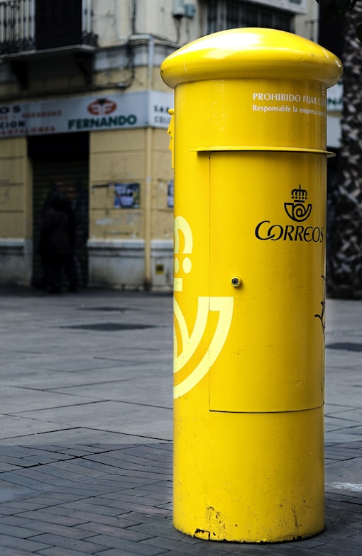 cylindrical yellow steel mail box