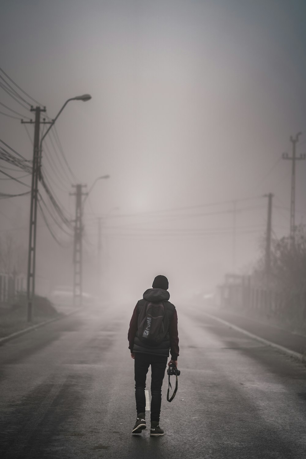 man standing on road