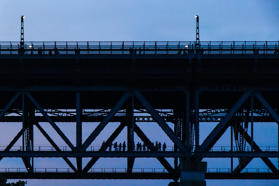 silhouette of people in bridge