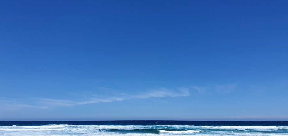 body of water under blue sky