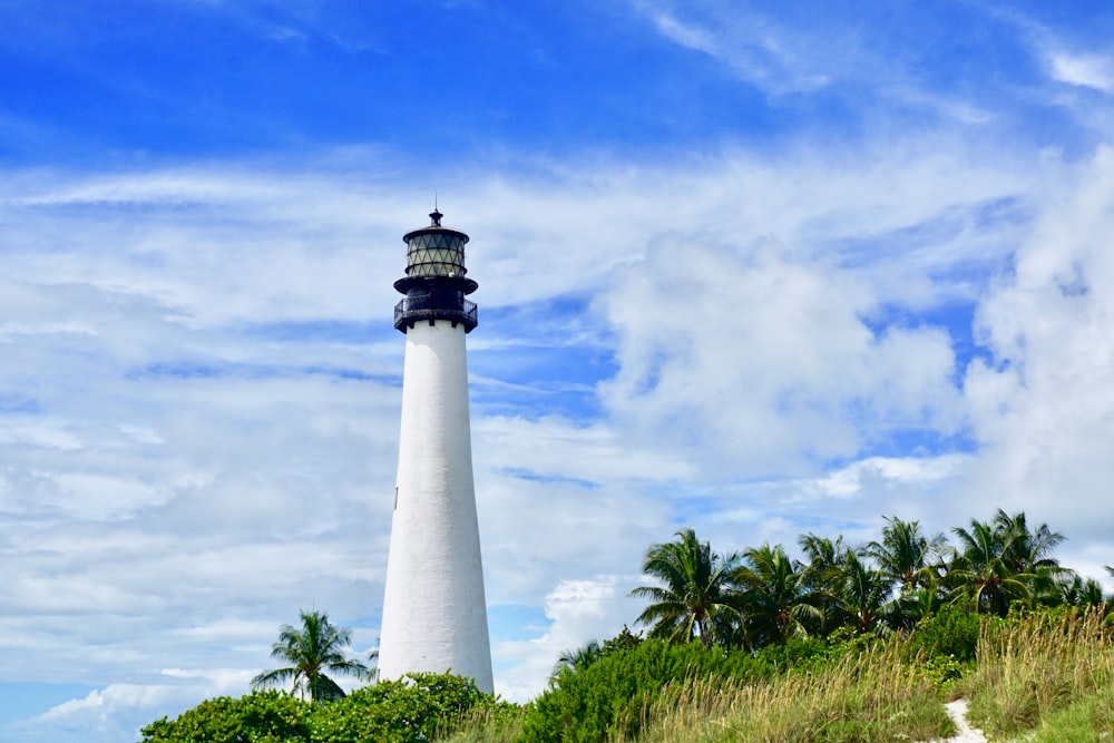 white lighthouse on hill