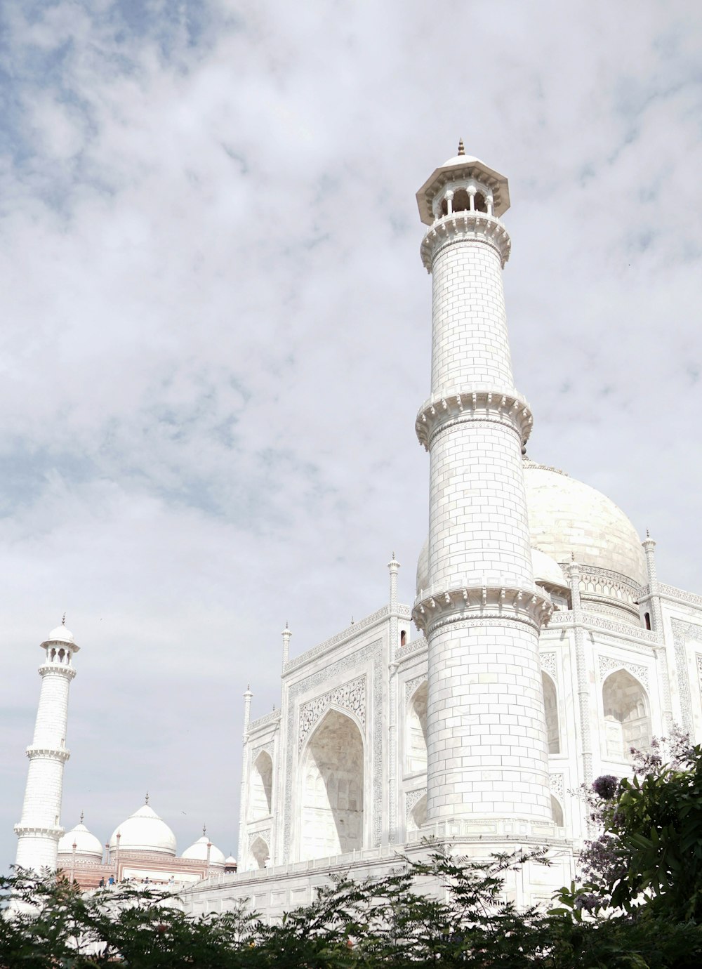 white mosque near trees under white and blue sky