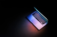 silver macbook air on black table