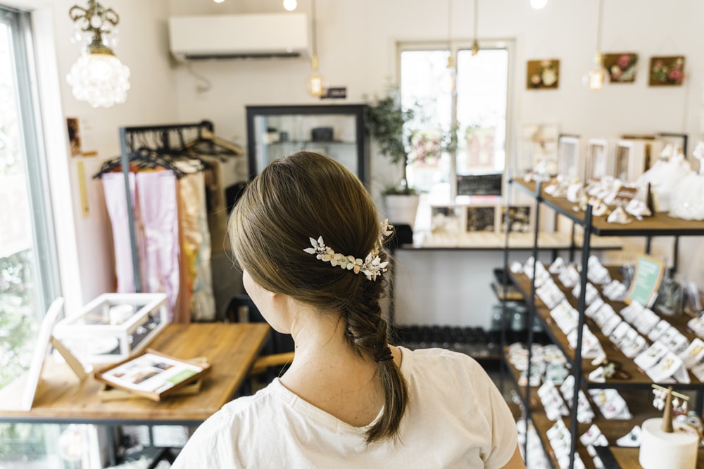 woman with braided hair using floral hairclip