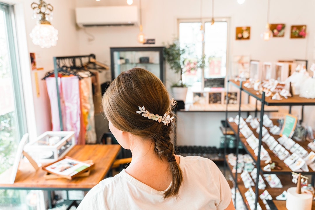woman with braided hair using floral hairclip