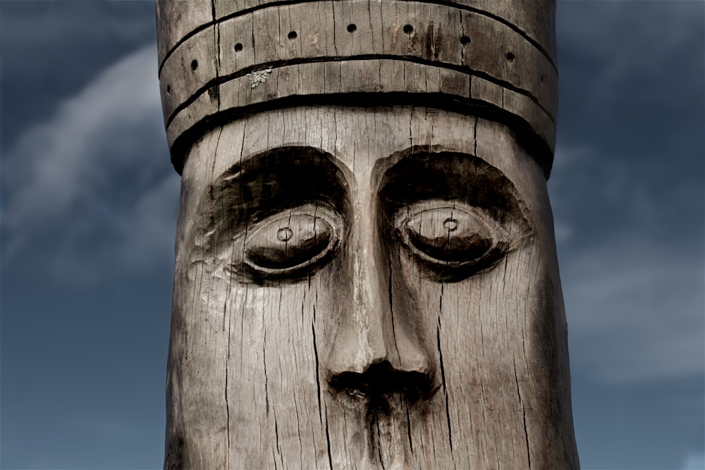 close-up photography of brown wooden statue during daytime