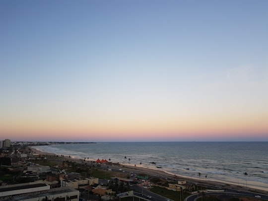 aerial photography of houses, buildings and people on beach viewing calm sea in Salvador Brasil