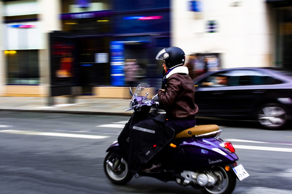 person driving the purple motor scooter