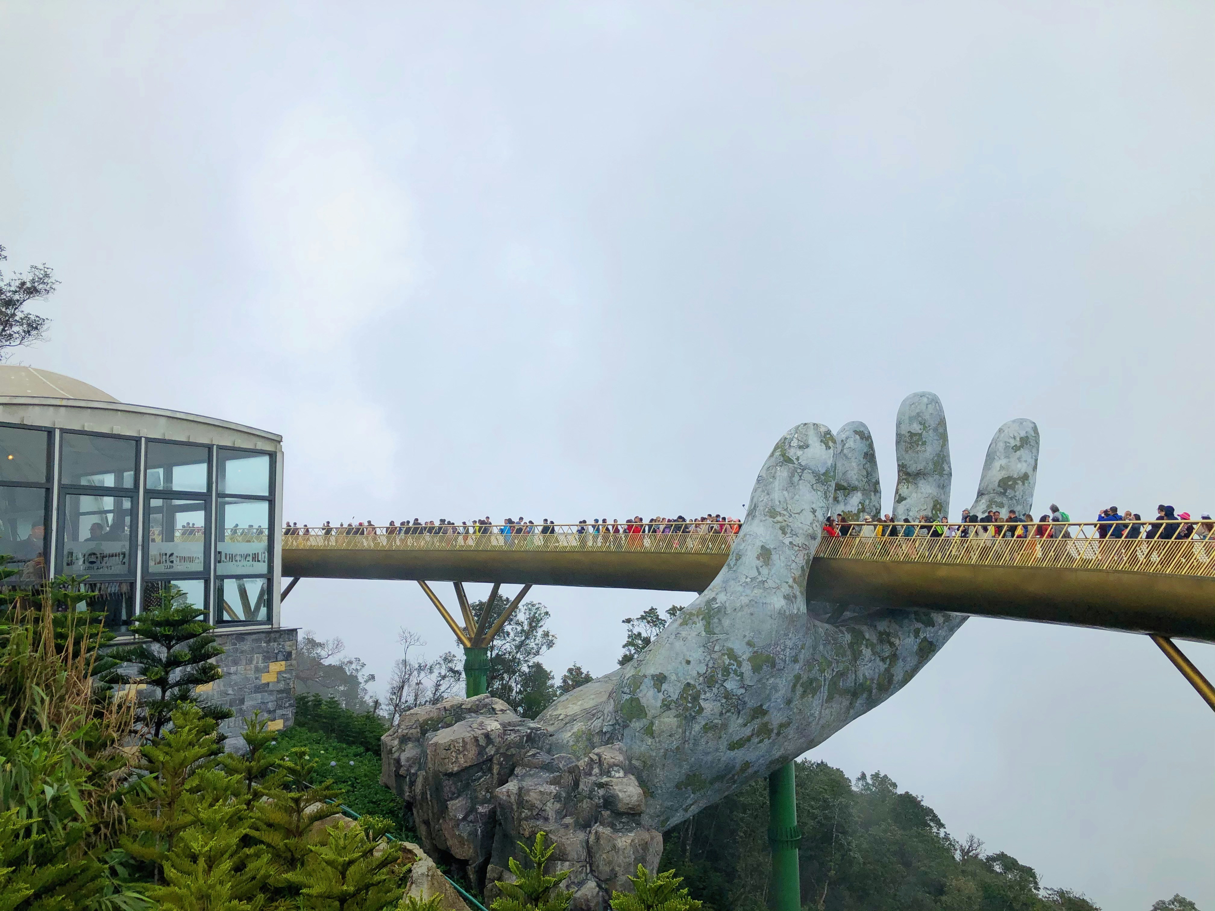 photography of people walking on bridge during daytime