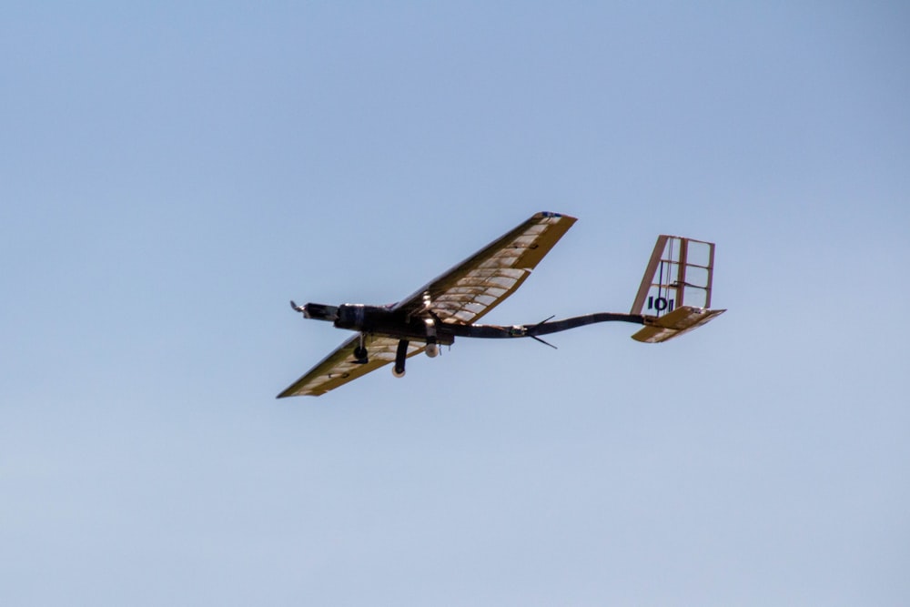 flying brown helicopter during daytime