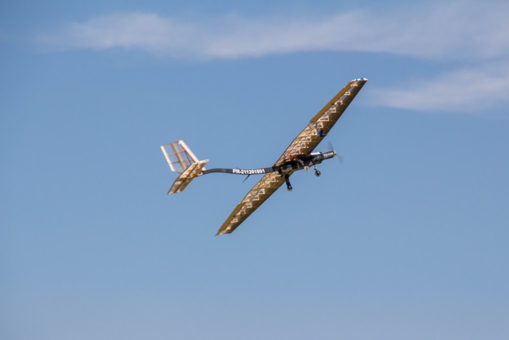 flying brown helicopter during daytime