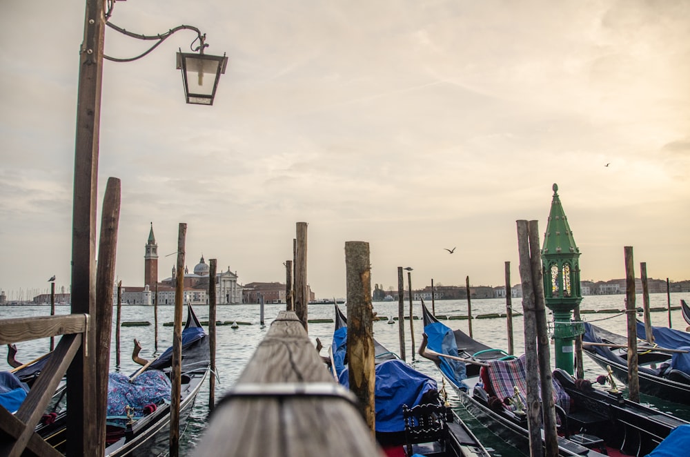 a pier with many gondolas in the water