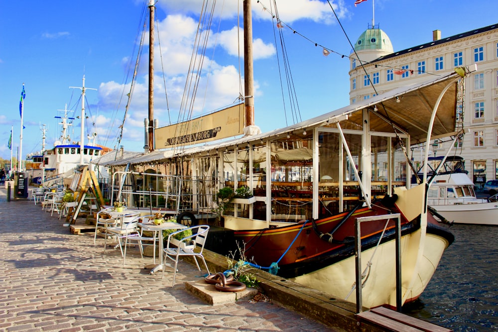 brown yacht near buildings during daytime