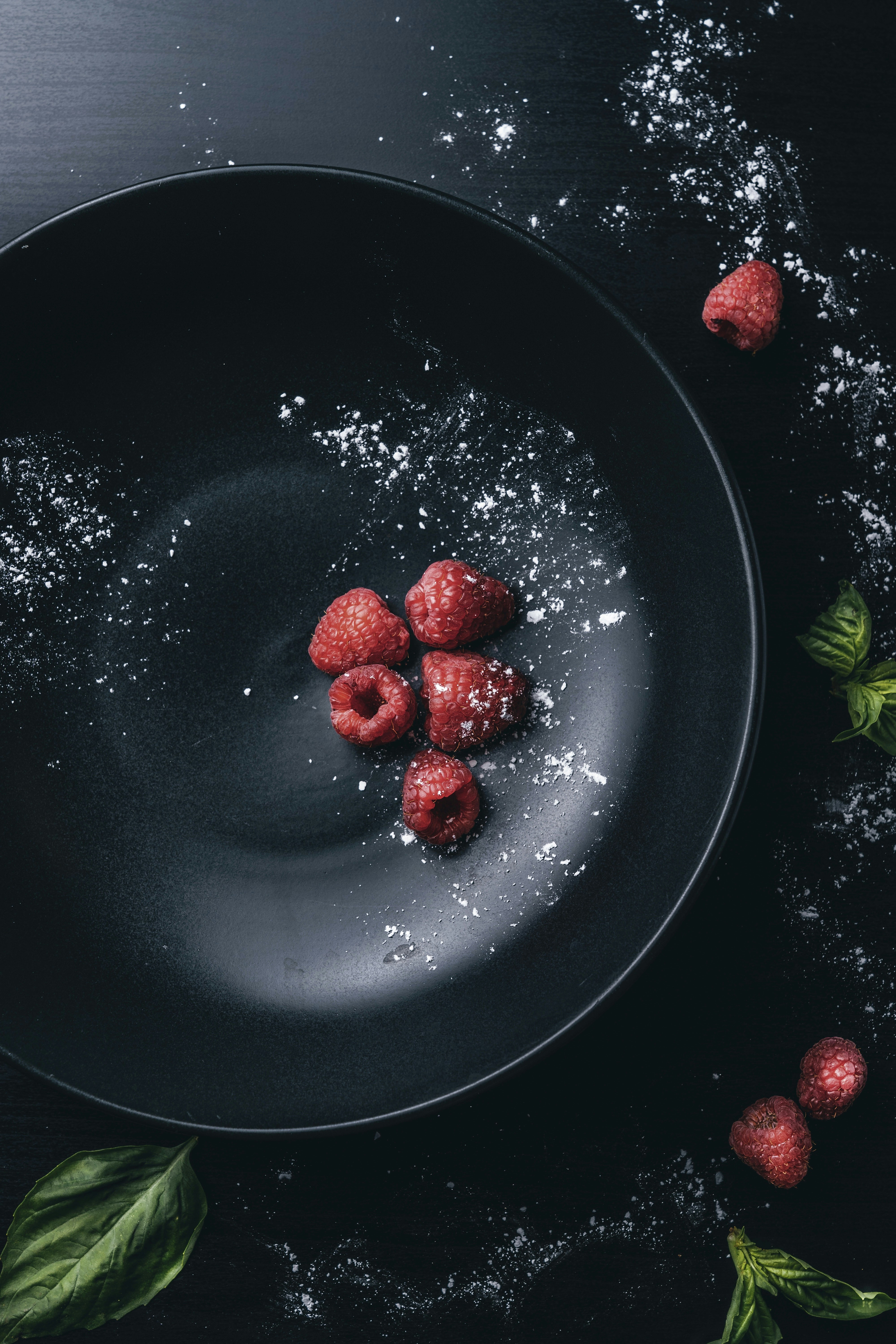 Mood food photography of raspberries.