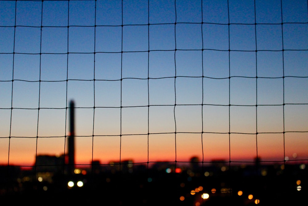 a view of a city from behind a fence