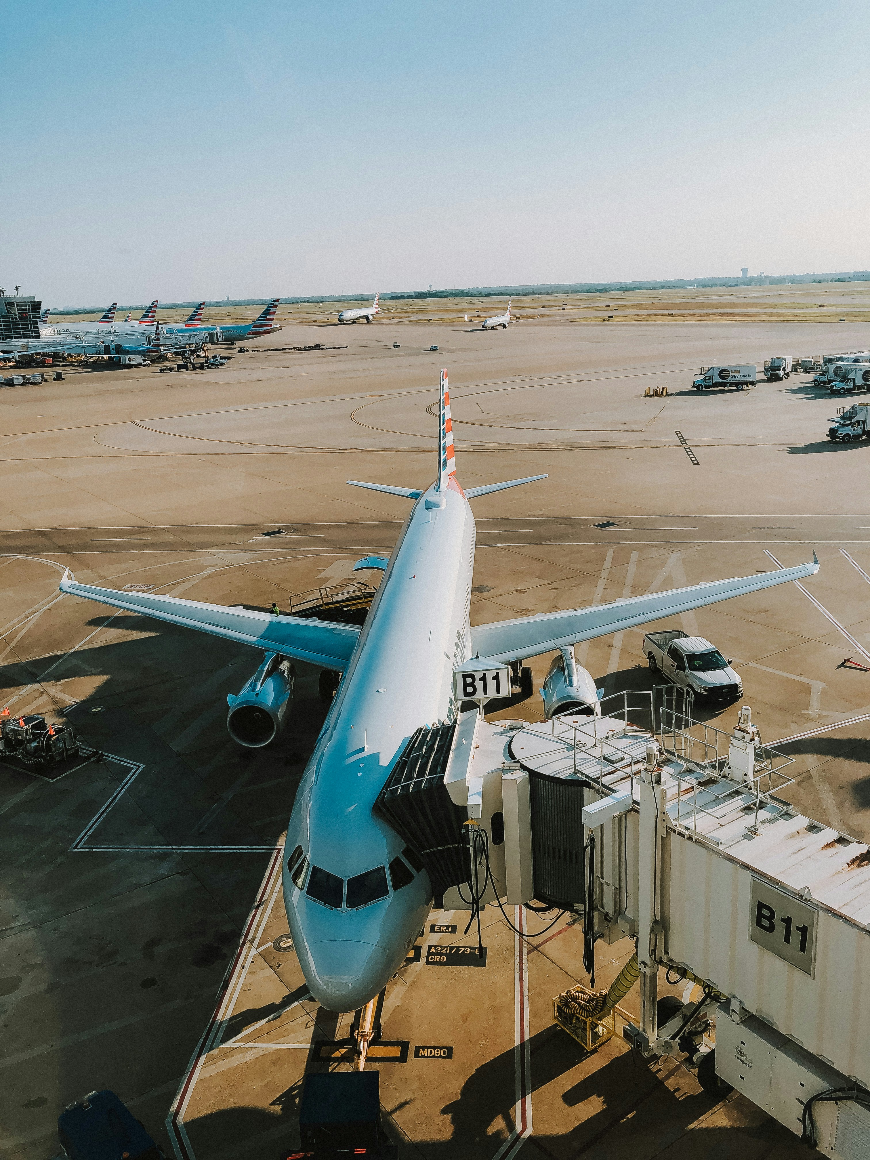 white pickup truck near white passenger airplane