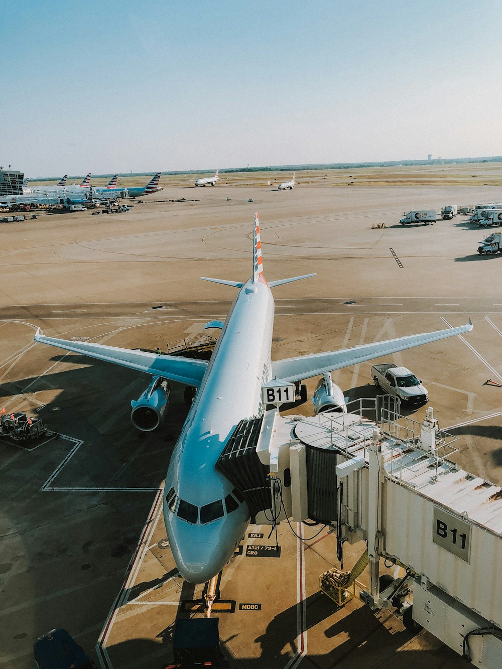 white pickup truck near white passenger airplane