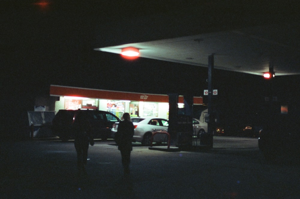 People and cars at the gas station during night photo – Free Machine Image  on Unsplash