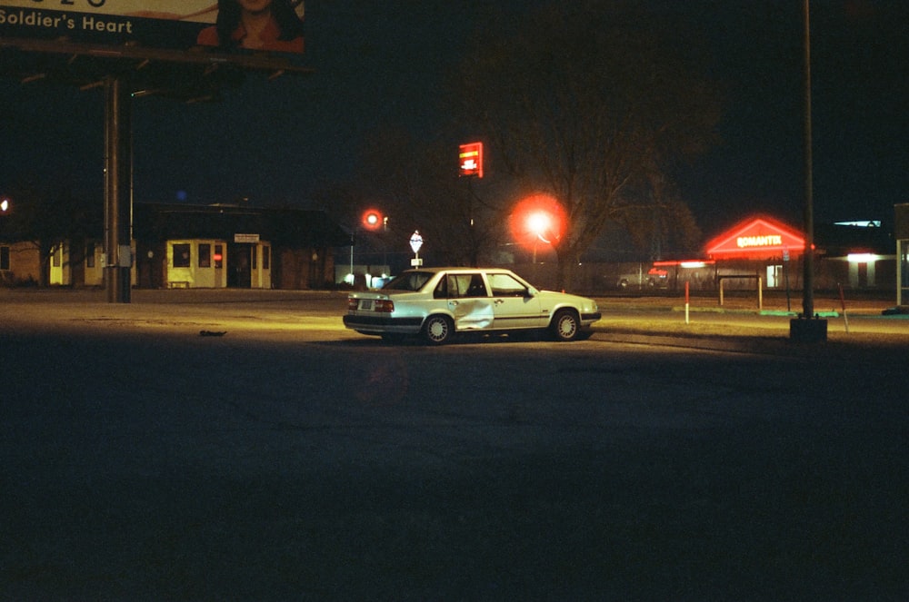 white sedan parked during night