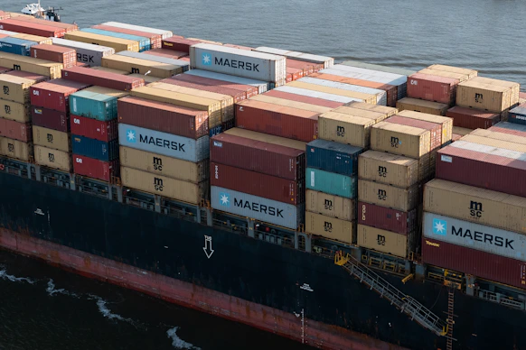 A cargo ship loaded with containers, symbolizing international trade.