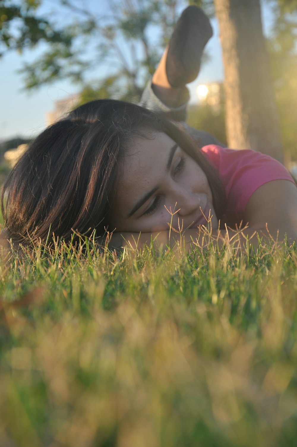 woman lying on the grass field