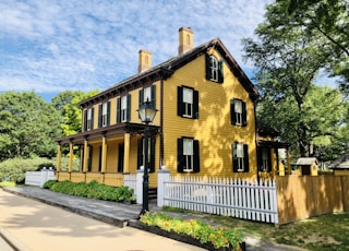 yellow house beside trees