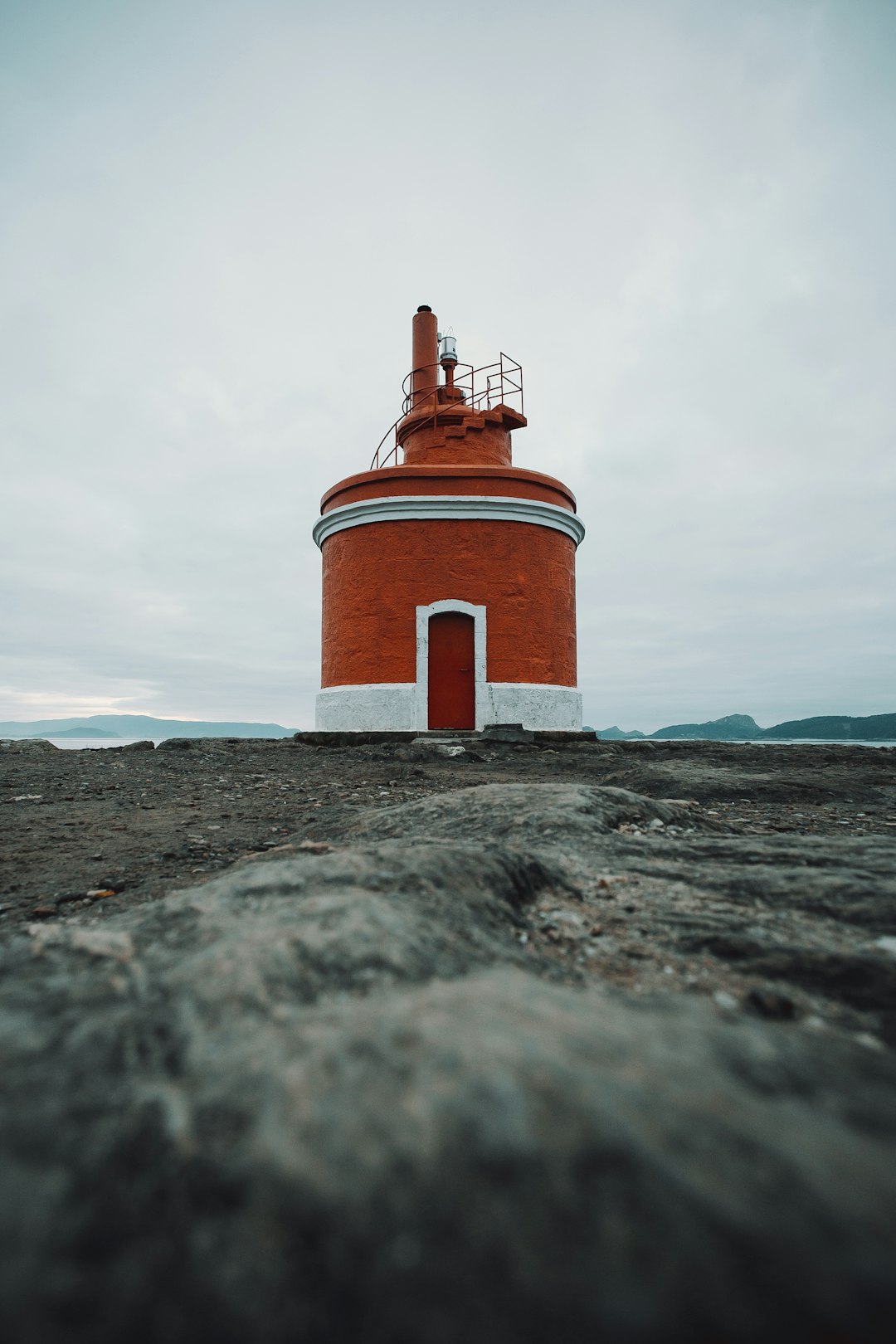 brown and white lighthouse under white sky