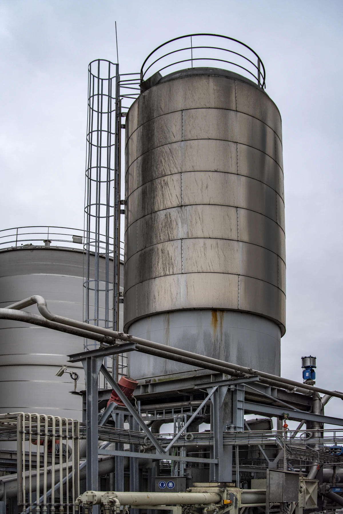 Gray industrial factory and tank structure under an overcast sky